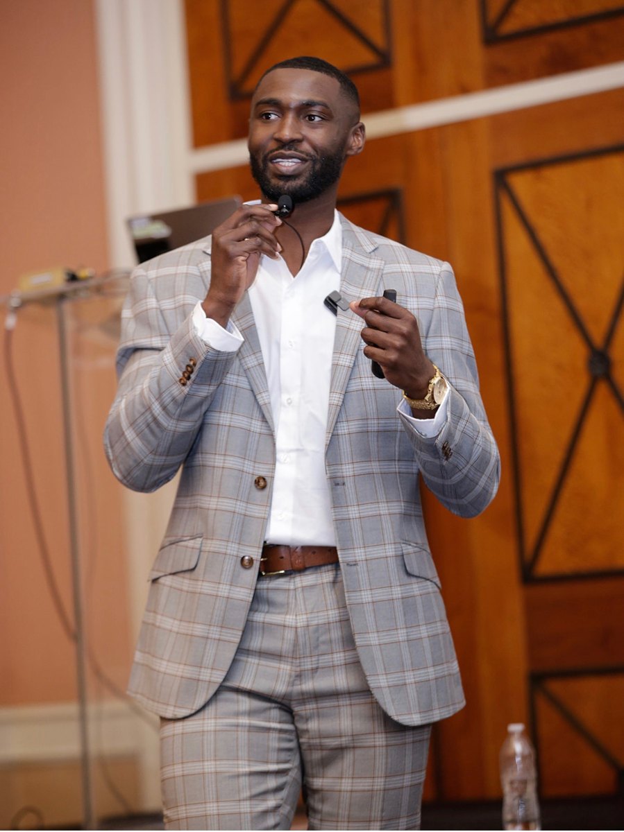 Kingsley Ifedi speaking on stage at the National Dental Association convention